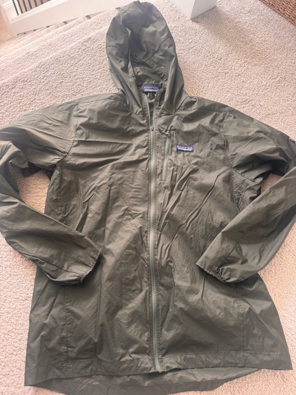 Patagonia Men's Olive Green Hooded shell windbreaker jacket.